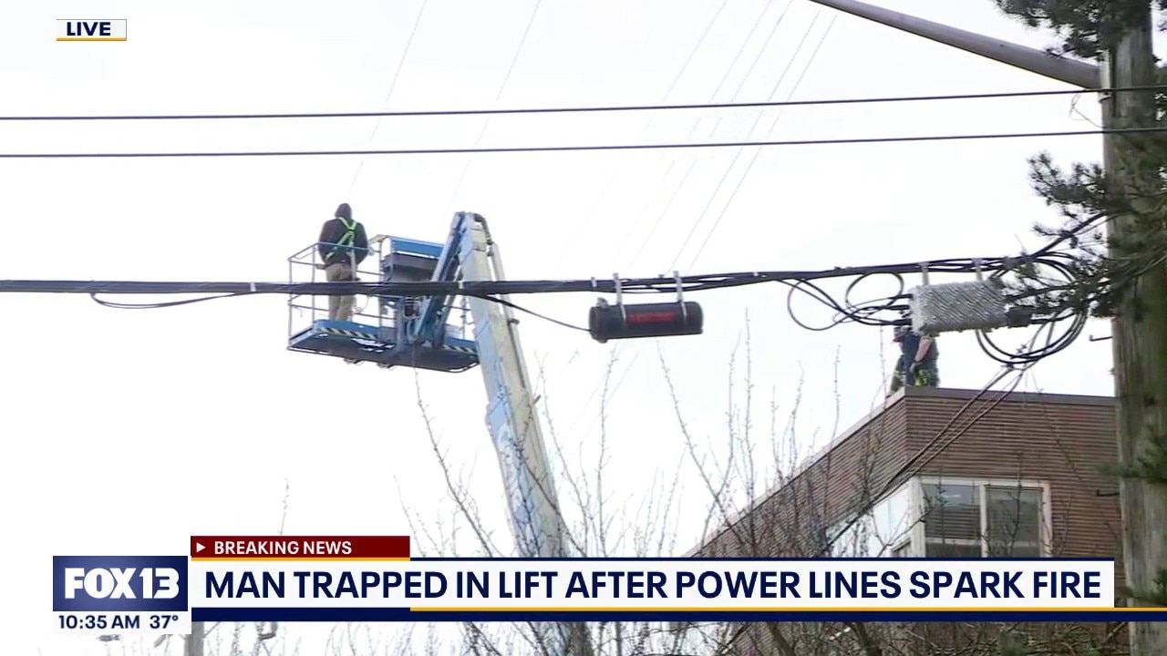 Man trapped in lift after power lines spark fire in Seattle