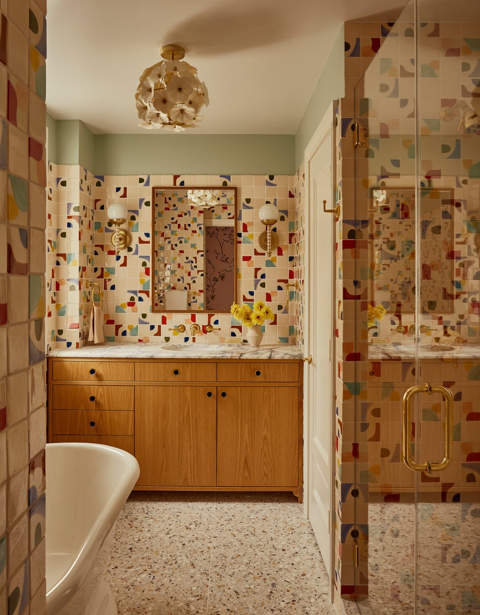 Brightly designed bathroom with colorful tiled walls and modern fixtures.