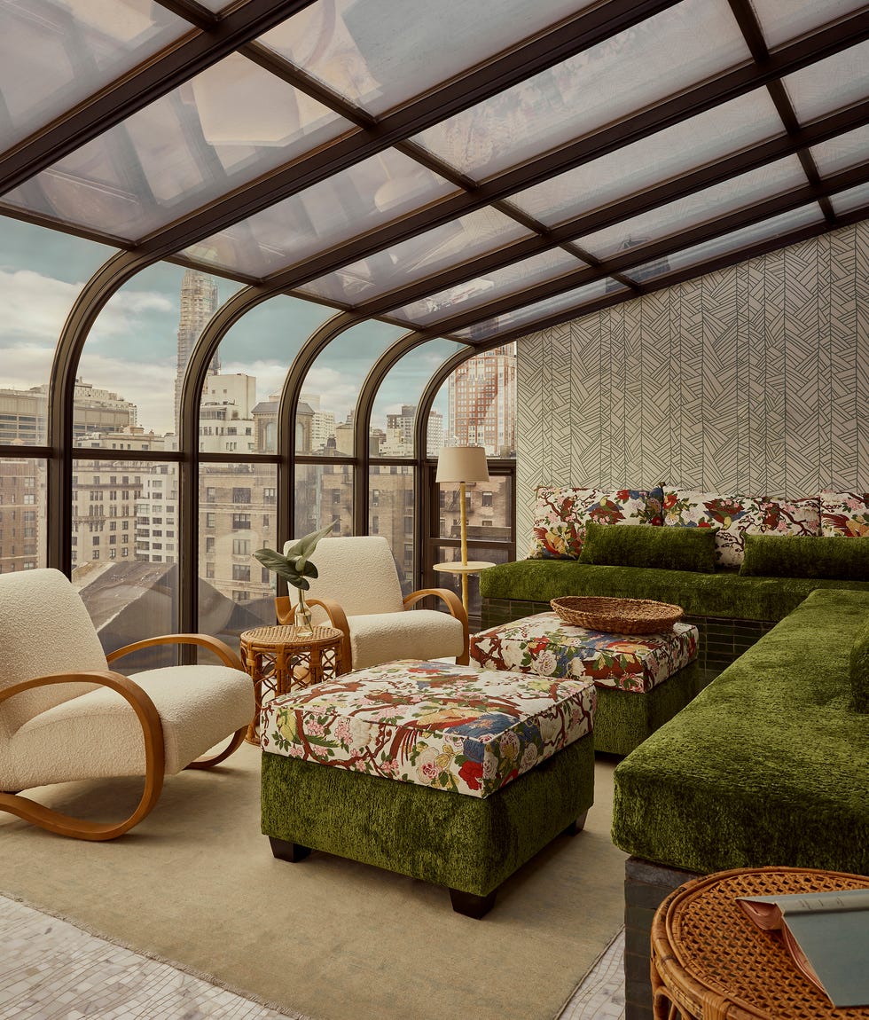 Cozy indoor lounge area with unique furniture and city view.