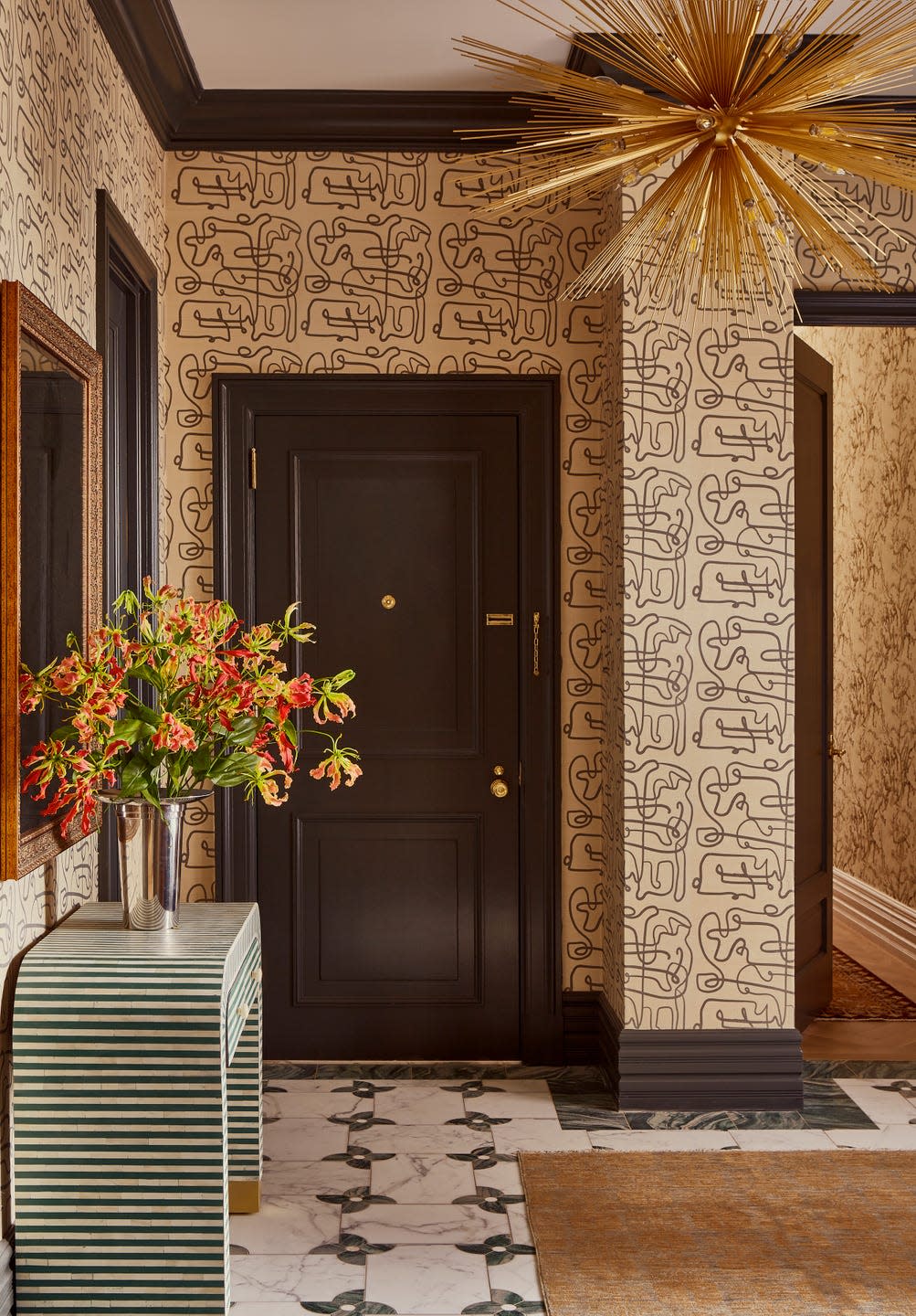 Entryway featuring a decorative wall and flowers.