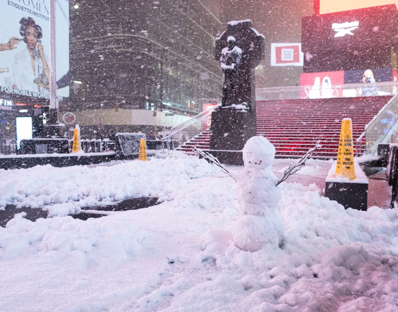 NEW YORK, NEW YORK - FEBRUARY 22: A snowman is seen in Times Square on February 22, 2026 in New York, New York. The northeast U.S. is bracing for an intense nor'easter with blizzard conditions, heavy snow, and strong winds. (Photo by Noam Galai/Getty Images)