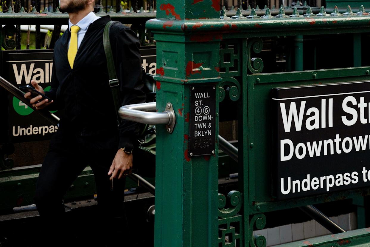 Man walks up Wall Street subway station