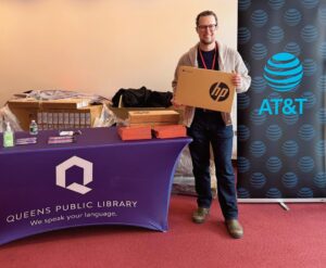 QEDC Executive Director Ben Guttmann held a computer during the giveaway.