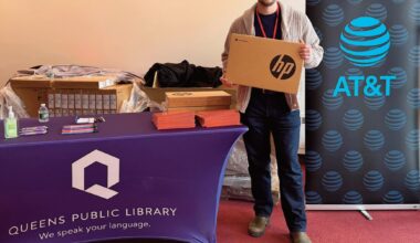 QEDC Executive Director Ben Guttmann held a computer during the giveaway.