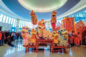 Traditional lion dancers gather in the Grand Lobby at Resorts World New York City to wel­come the Year of the Horse.