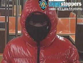 Robber in red: Cops seek bundled-up bandit who slashed man in Brooklyn subway for his wallet