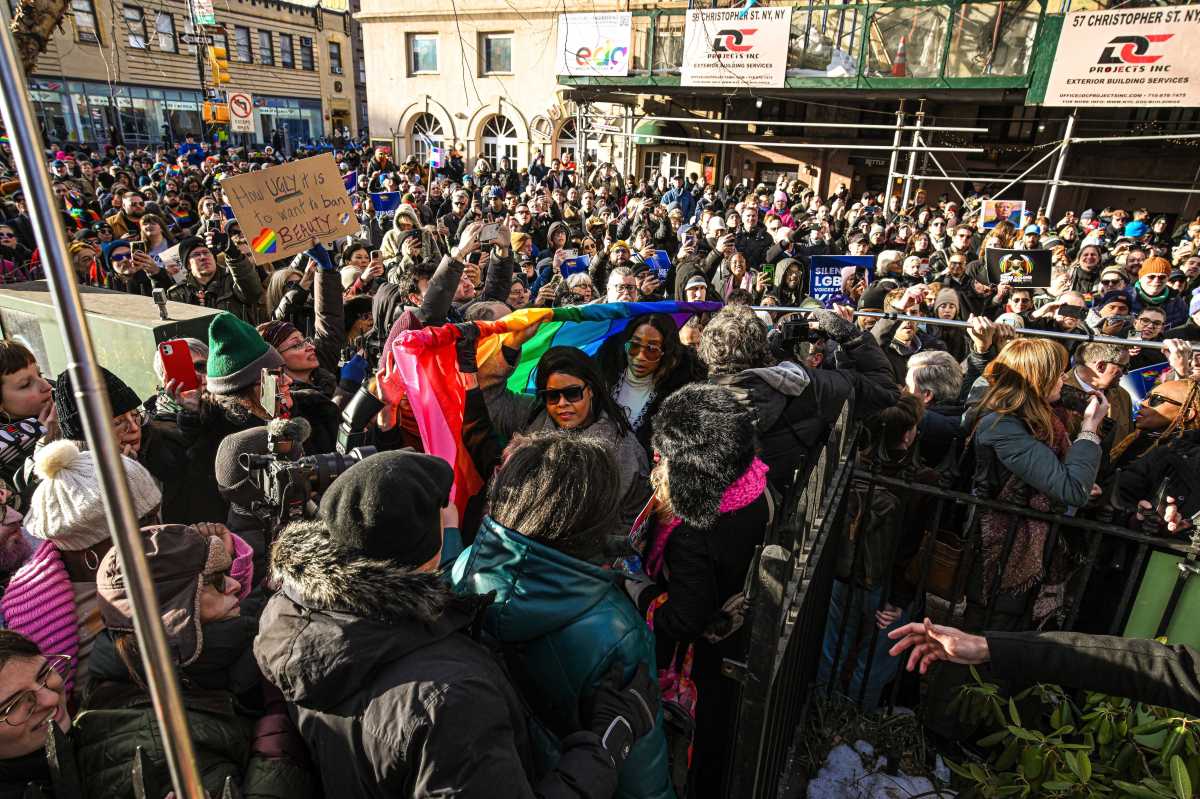 The Pride flag makes its way through the crowd.