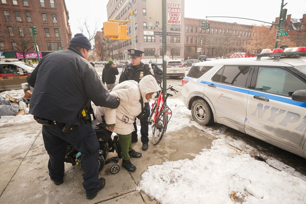 cops help susan king up from the sidewalk