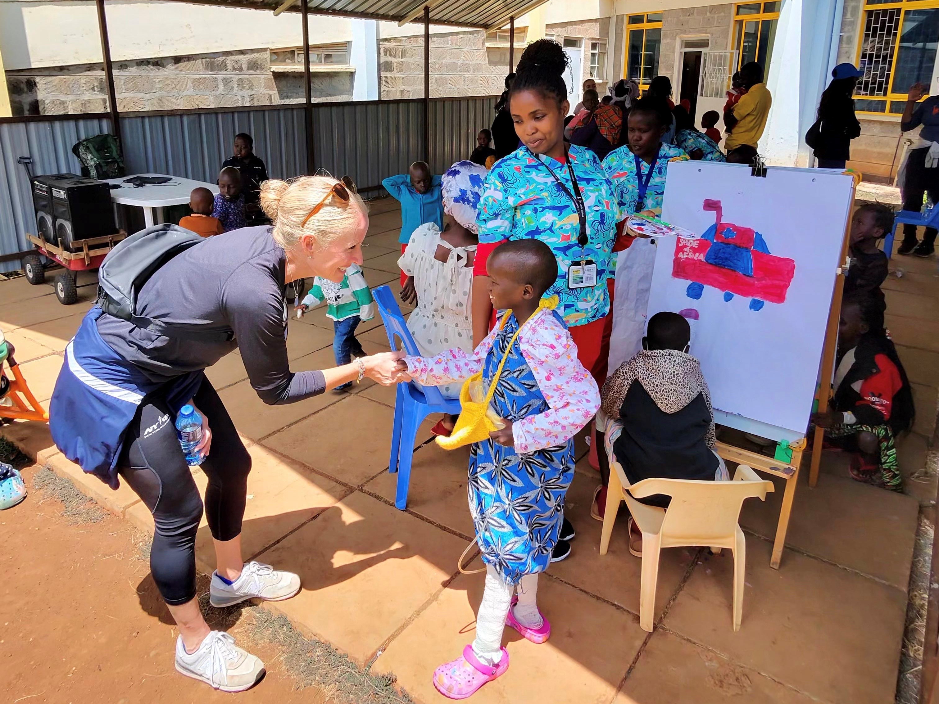 Christine Burke visits with a young patient at the Shoe4Africa children's hospital, Kenya, February 2026. 