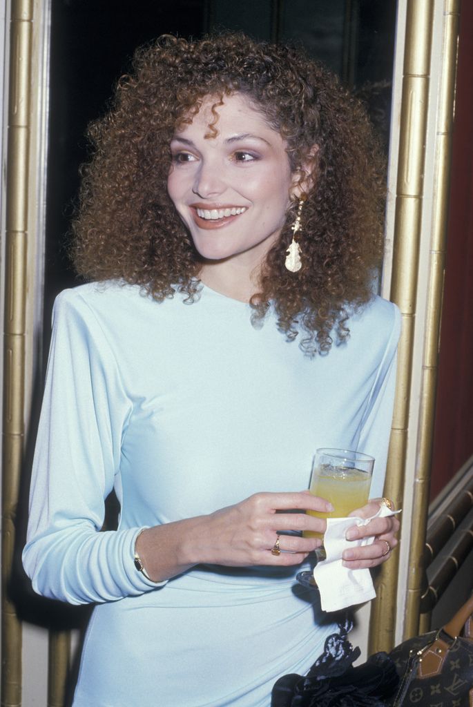 mary elizabeth mastrantonio smiling blue dress