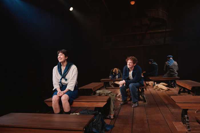 actors perform on a stage with a dark background