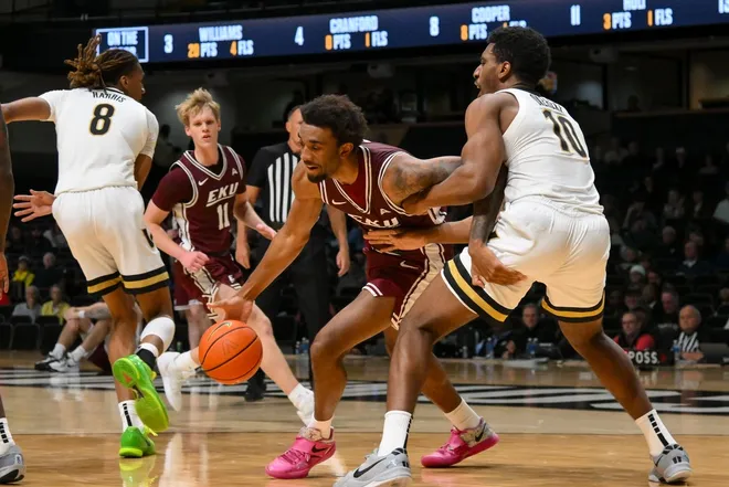 Nov 12, 2025; Nashville, Tennessee, USA; Eastern Kentucky Colonels forward Montavious Myrick (13) drives through the lane past Vanderbilt Commodores forward Ak Okereke (10) during the second half at Memorial Gymnasium.