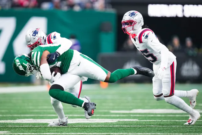 New England Patriots safety Dell Pettus (24) tackles New York Jets tight end Stone Smartt (84) during a game at MetLife Stadium, Dec 28, 2025, East Rutherford, NJ, USA.