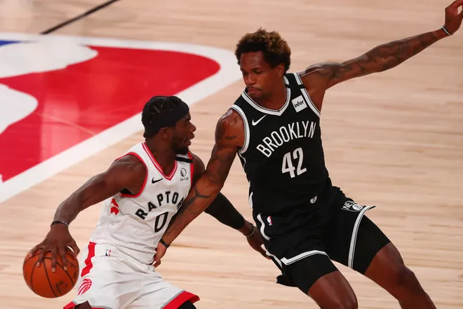 Aug 17, 2020; Orlando, Florida, USA; Toronto Raptors guard Terence Davis (0) moves the ball while Brooklyn Nets forward Lance Thomas (42) defends during the second half in game one of the first round of the 2020 NBA Playoffs at AdventHealth Arena. Mandatory Credit: Kim Klement-USA TODAY Sports