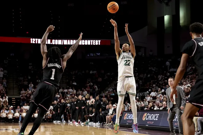 Nov 21, 2025; College Station, Texas, USA; Manhattan Jaspers guard Terrance Jones (22) shoots a three point basket during the second half as against the Texas A&M Aggies at Reed Arena.Maria Lysaker-Imagn Images