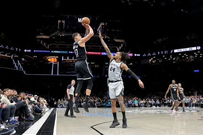Feb 26, 2026; Brooklyn, New York, USA; Brooklyn Nets forward Michael Porter Jr. (17) shoots a three point shot against San Antonio Spurs guard Devin Vassell (24) during the fourth quarter at Barclays Center.
