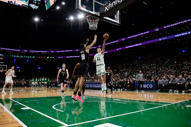 Feb 27, 2026; Boston, Massachusetts, USA; Boston Celtics guard Payton Pritchard (11) drives to the basket while Brooklyn Nets forward Josh Minot (00) defends during the second half at TD Garden. Mandatory Credit: Bob DeChiara-Imagn Images