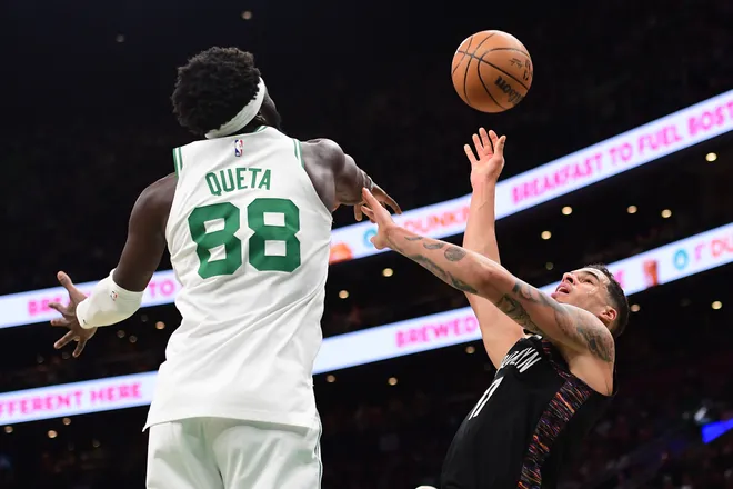 Feb 27, 2026; Boston, Massachusetts, USA; Brooklyn Nets forward Michael Porter Jr. (17) shoots the ball while Boston Celtics center Neemias Queta (88) defends during the first half at TD Garden. Mandatory Credit: Bob DeChiara-Imagn Images