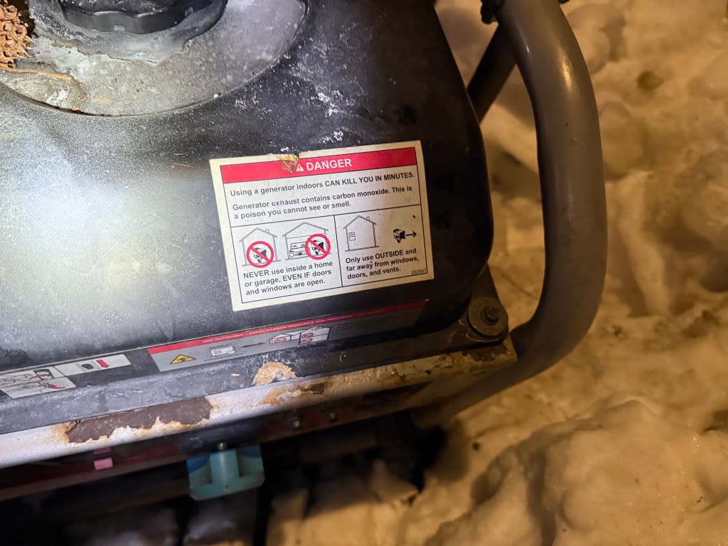 A sign on the generator next to the van warning against using it indoors or too close to windows or vents. David Burns/@FD4D