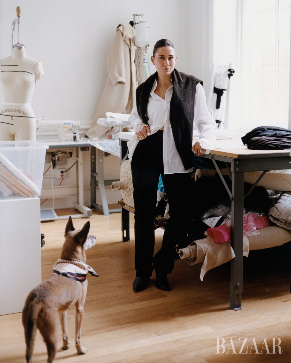 a fashion designer in a studio with a dog