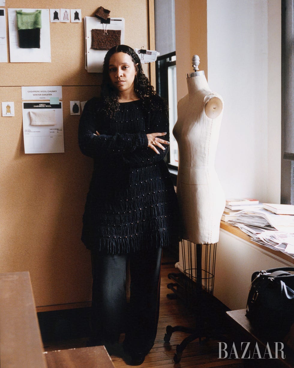 fashion designer in a studio setting with design materials