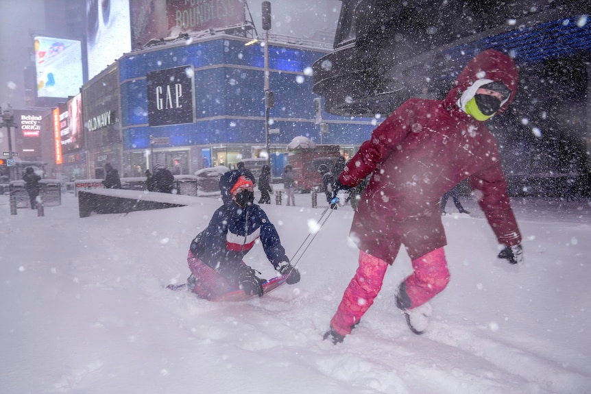 People play in Times Square during the snowstorm.