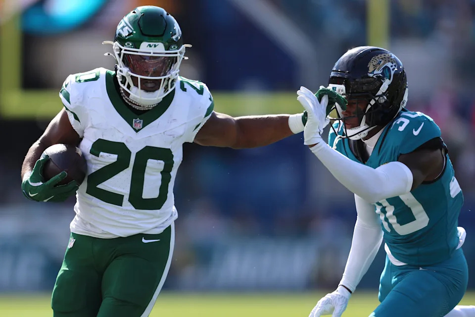 Dec 14, 2025; Jacksonville, Florida, USA; New York Jets running back Breece Hall (20) runs with the ball against Jacksonville Jaguars cornerback Montaric Brown (30) during the first quarter at EverBank Stadium. Mandatory Credit: Morgan Tencza-Imagn Images