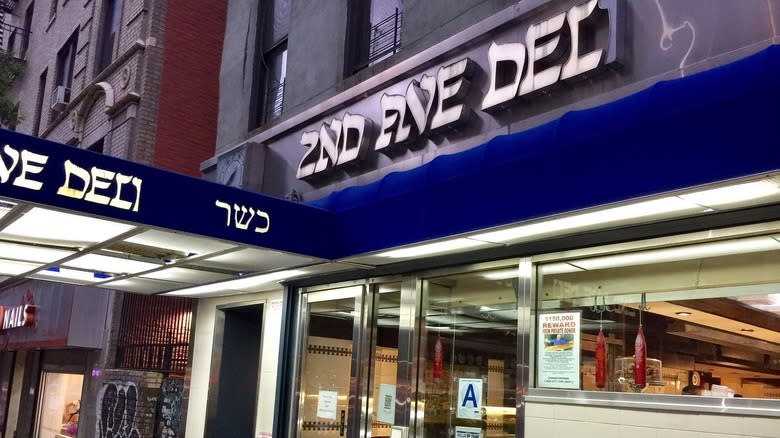 The exterior of 2nd Ave Deli, showing signage and windows