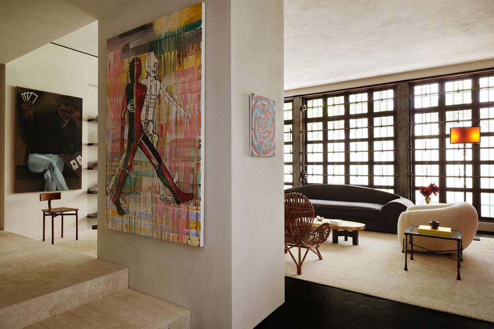 Modern living space with artwork and furniture.