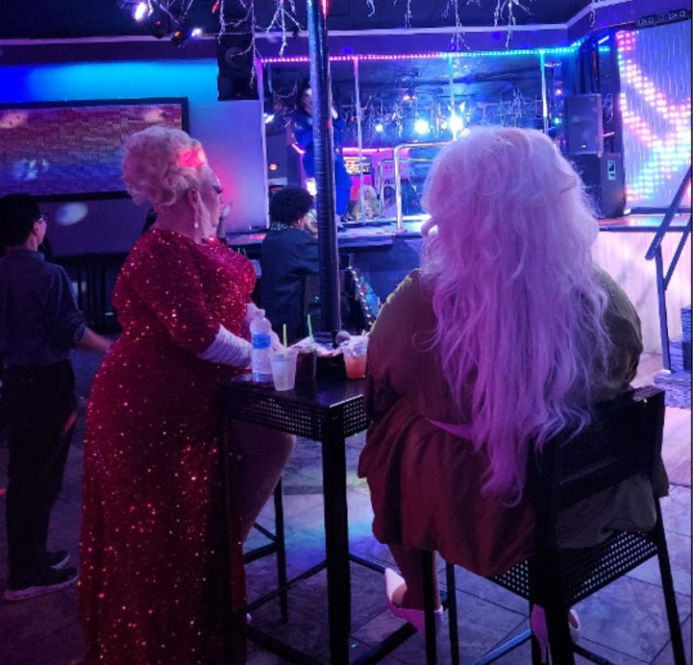 Hosts Vanna Vanity and Lolita Chanel watching Aria Venus perform.