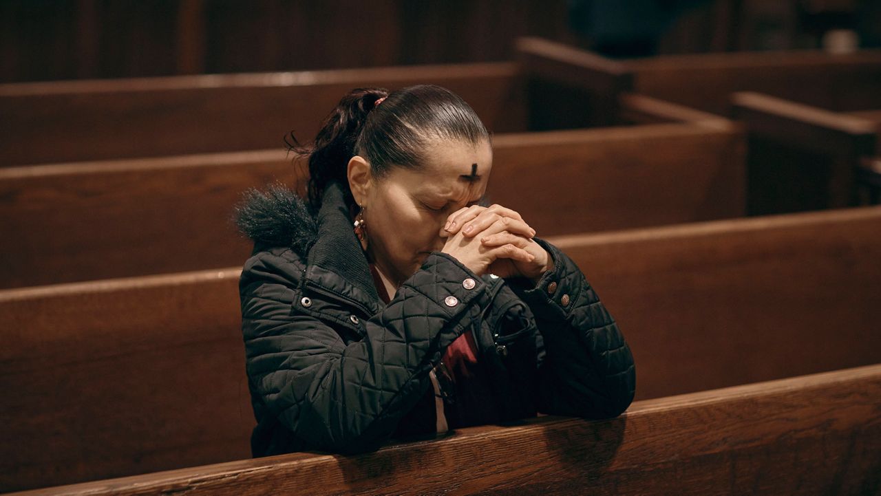 A woman prays inside St. Patrick's Cathedral on Ash Wednesday, March 5, 2025, in New York. (AP Photo/Andres Kudacki)