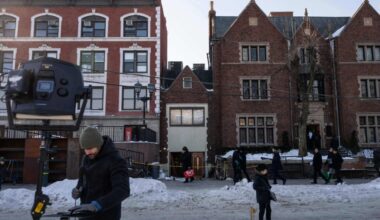 Members of the media work near the scene where a car slammed into the entrance of the Chabad Lubavitch world headquarters, Thursday, Jan. 29, 2026, in New York. (AP Photo/Yuki Iwamura)