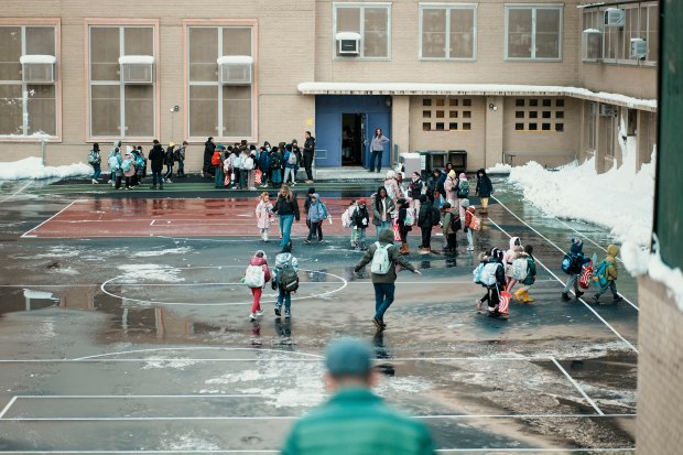 Children gather in a school yard before the start of school, Tuesday, Feb. 24, 2026, in New York. (AP Photo/Eduardo Munoz Alvarez)