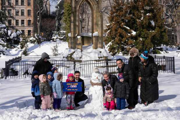 New York Mayor Zohran Mamdani and students of Pre-K and 3-K program pose for a picture with a snowman during a press conference in Morningside Heights, Wednesday, Feb. 25, 2026, in New York. (AP Photo/Yuki Iwamura)