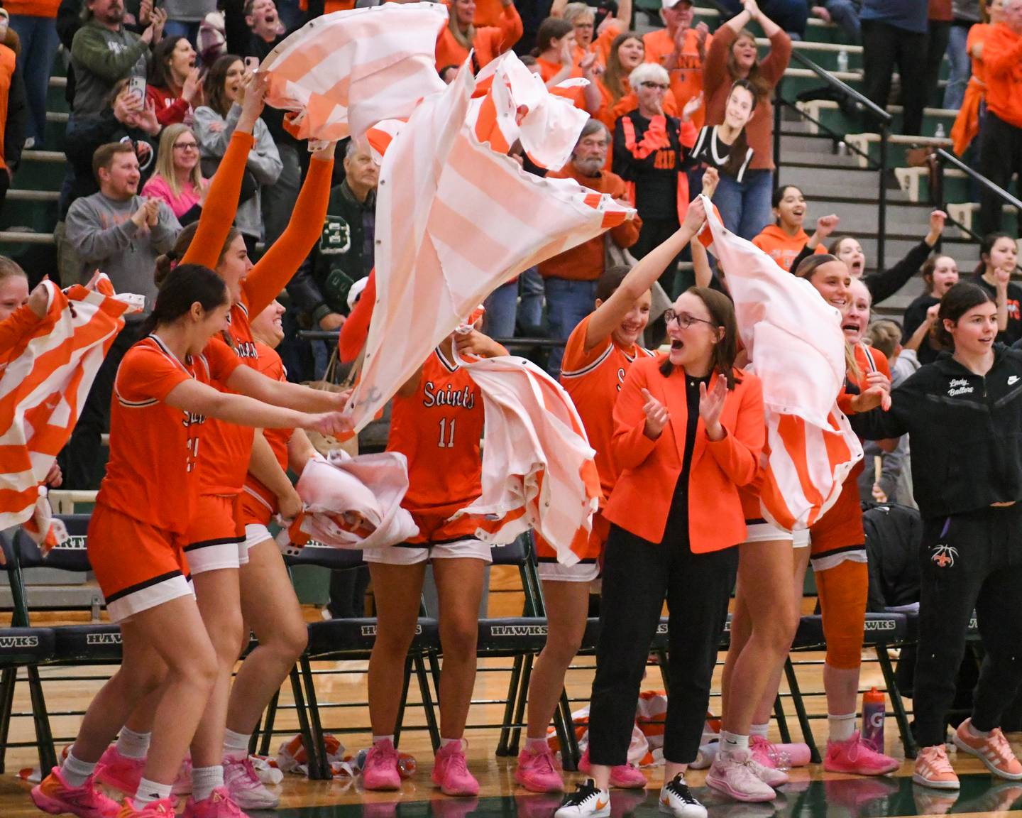 St. Charles East's head coach Katie Claussner is all smiles as the bench celebrates their win over Glenbard West during the 4A Sectional championship game on Thursday Feb. 26, 2026, held at Bartlett High School.