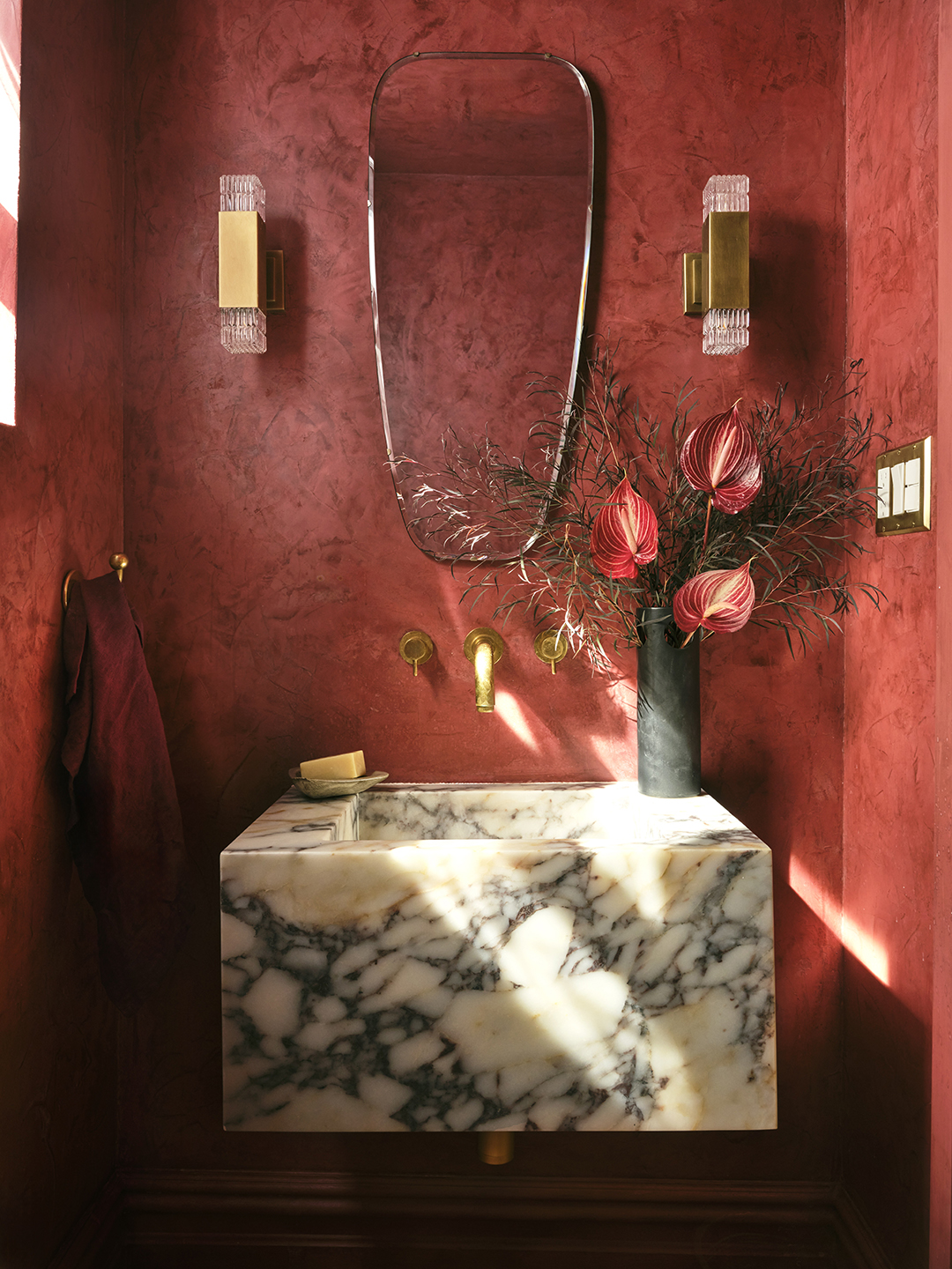 red powder room with marble sink