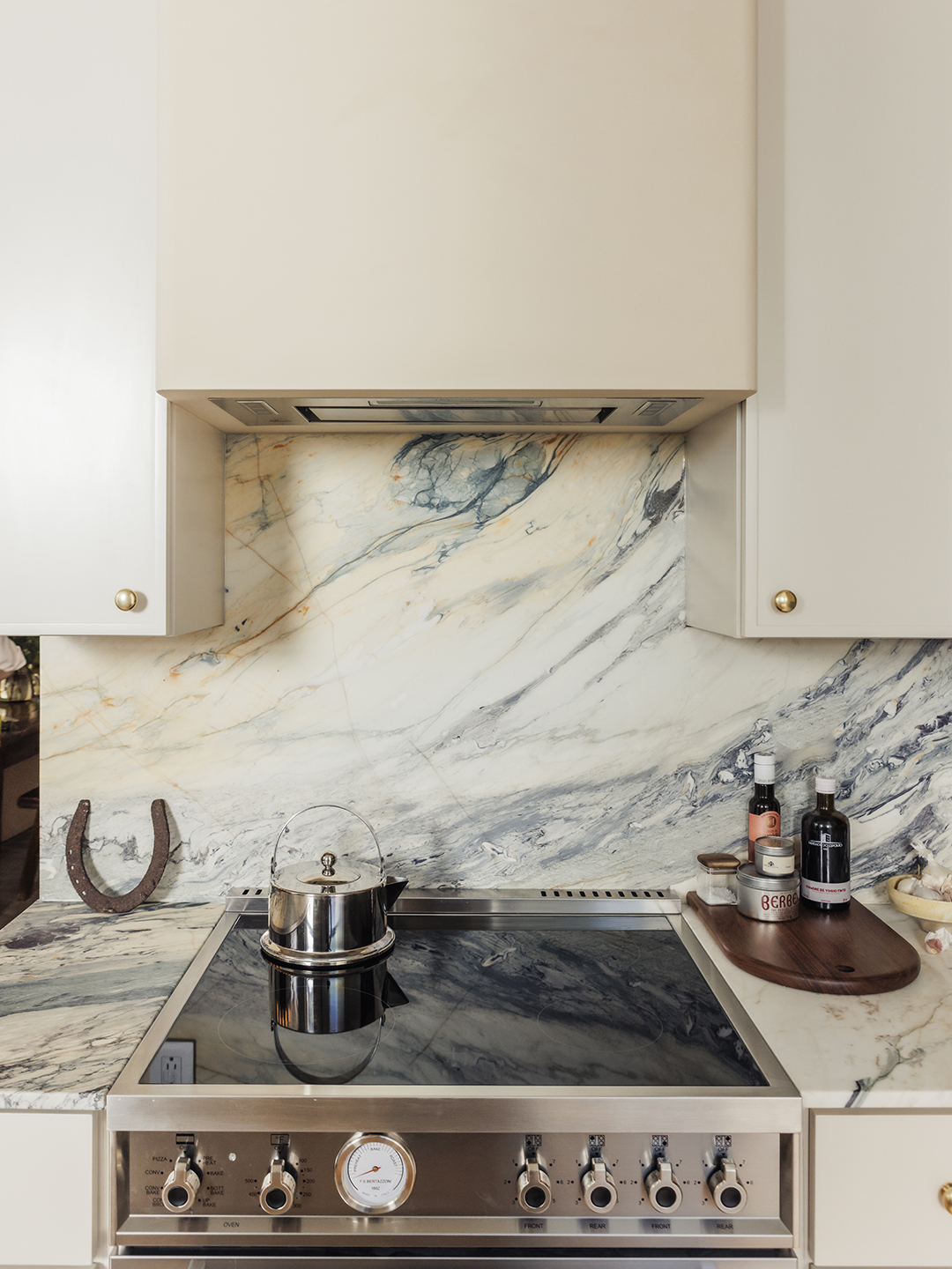 kitchen with detail shot of range and hood