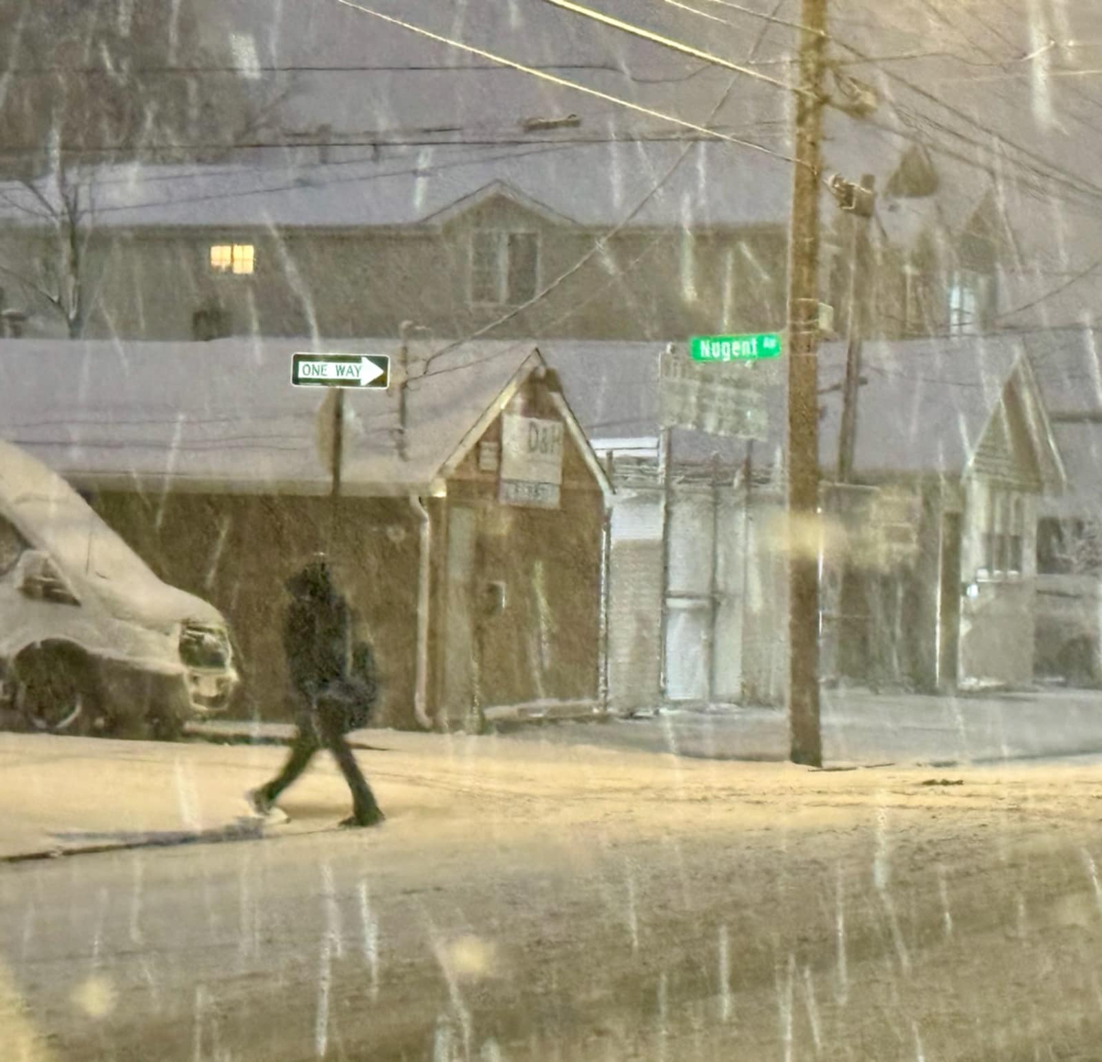 A person walks through the snow at the intersection of Nugent and Midland Avenues in Midland Beach on Sunday, Feb. 22, 2026.