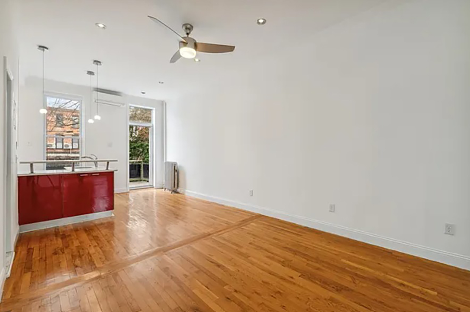 empty space with white walls and wood floors