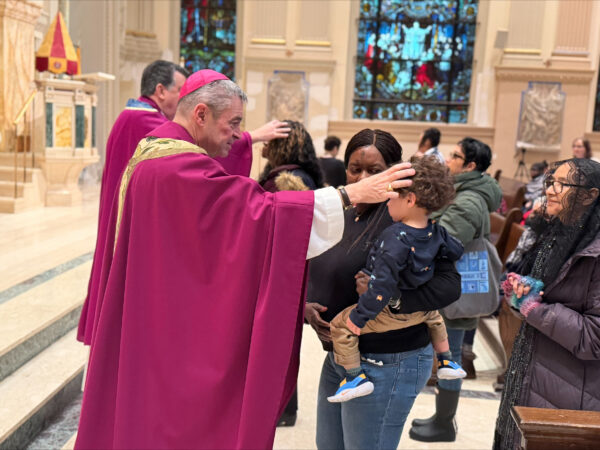 Bishop Robert Brennan places ashes on the foreheads of worshipers at St. James Cathedral. Photo courtesy John Quaglione/Diocese of Brooklyn