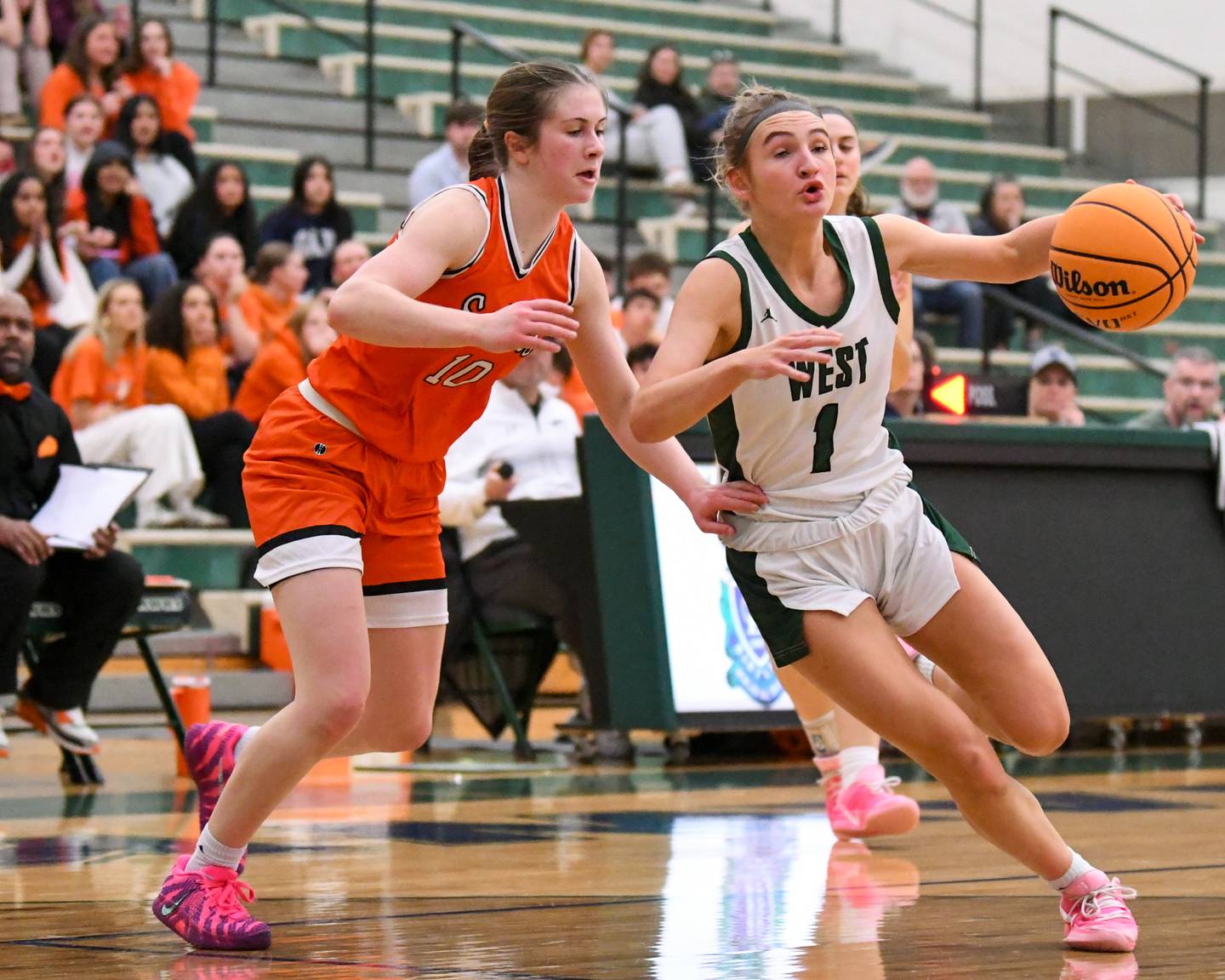 Glenbard West's Nina Hendricksen (1) drives around St. Charles East's Kathlyn Bainbridge (10) during the 4A Sectional championship game on Thursday Feb. 26, 2026, held at Bartlett High School.