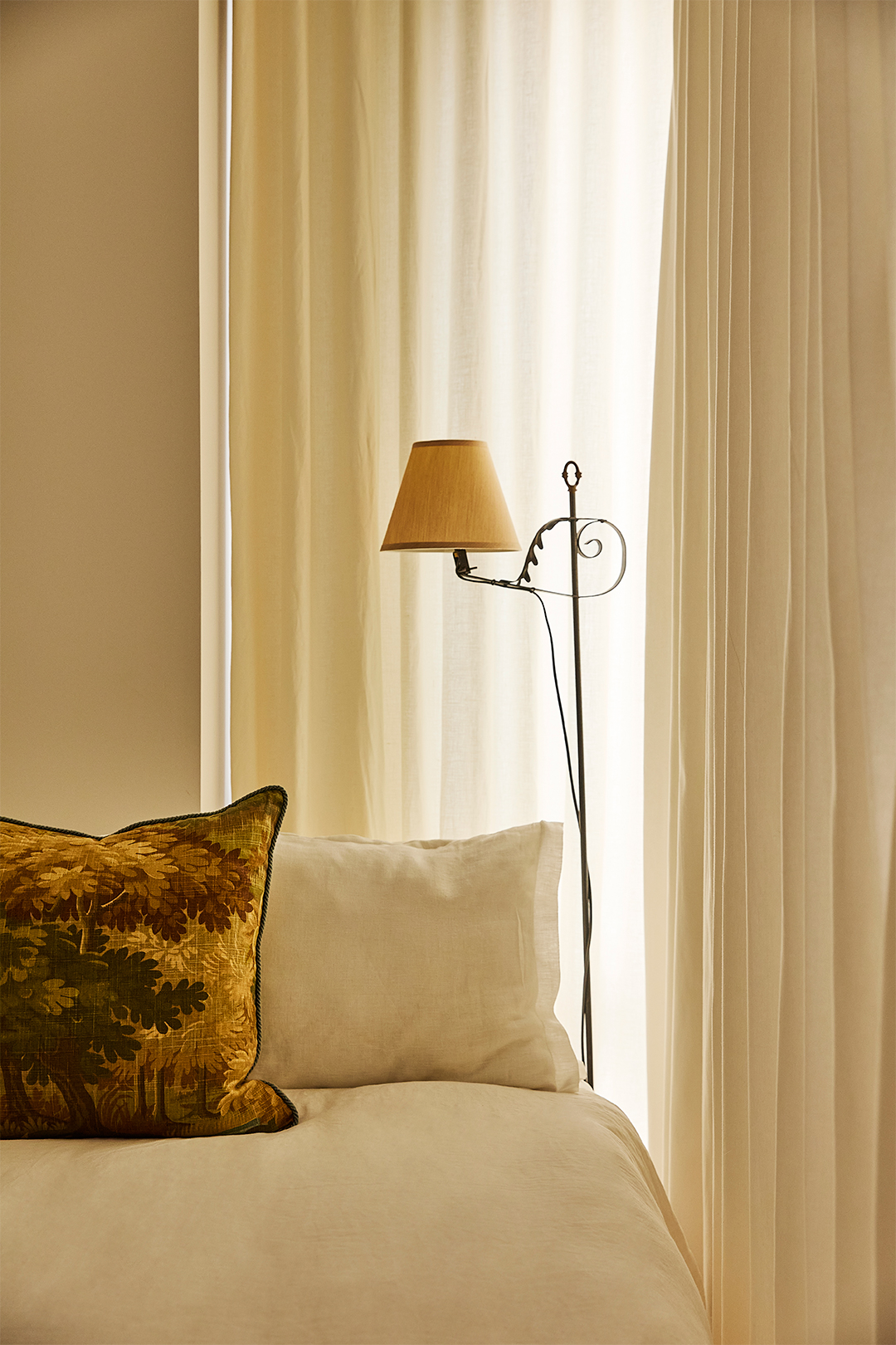 iron lamp next to bed