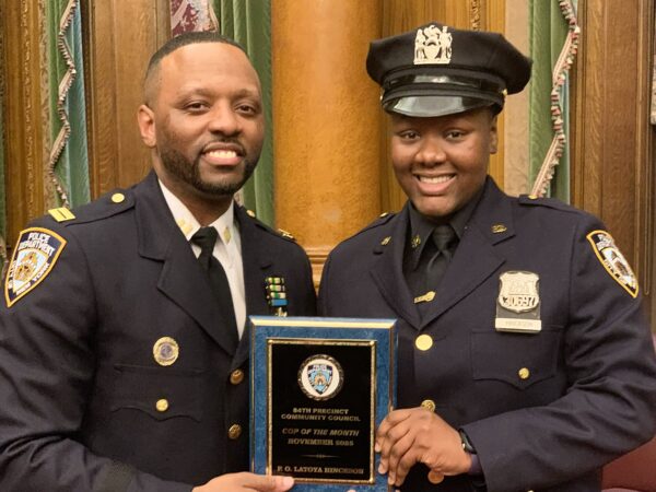 From left: 84th Precinct Commanding Officer Erek Powers, with police officer Latoya Hinckson. Hinckson and police officer Joshua Fyffe (not shown) were honored as Cops of the Month for November 2025. Photo: Mary Frost/Brooklyn Eagle