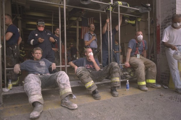 Firefighters catch their breath while working at the World Trade Center site on Sept. 13, 2001.