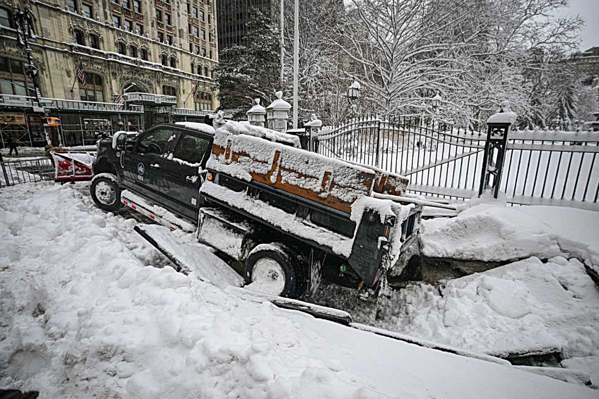 NYC BLIZZARD: Snowplow plunges into sidewalk sinkhole outside of City Hall as heavy snowfall weighs down Big Apple