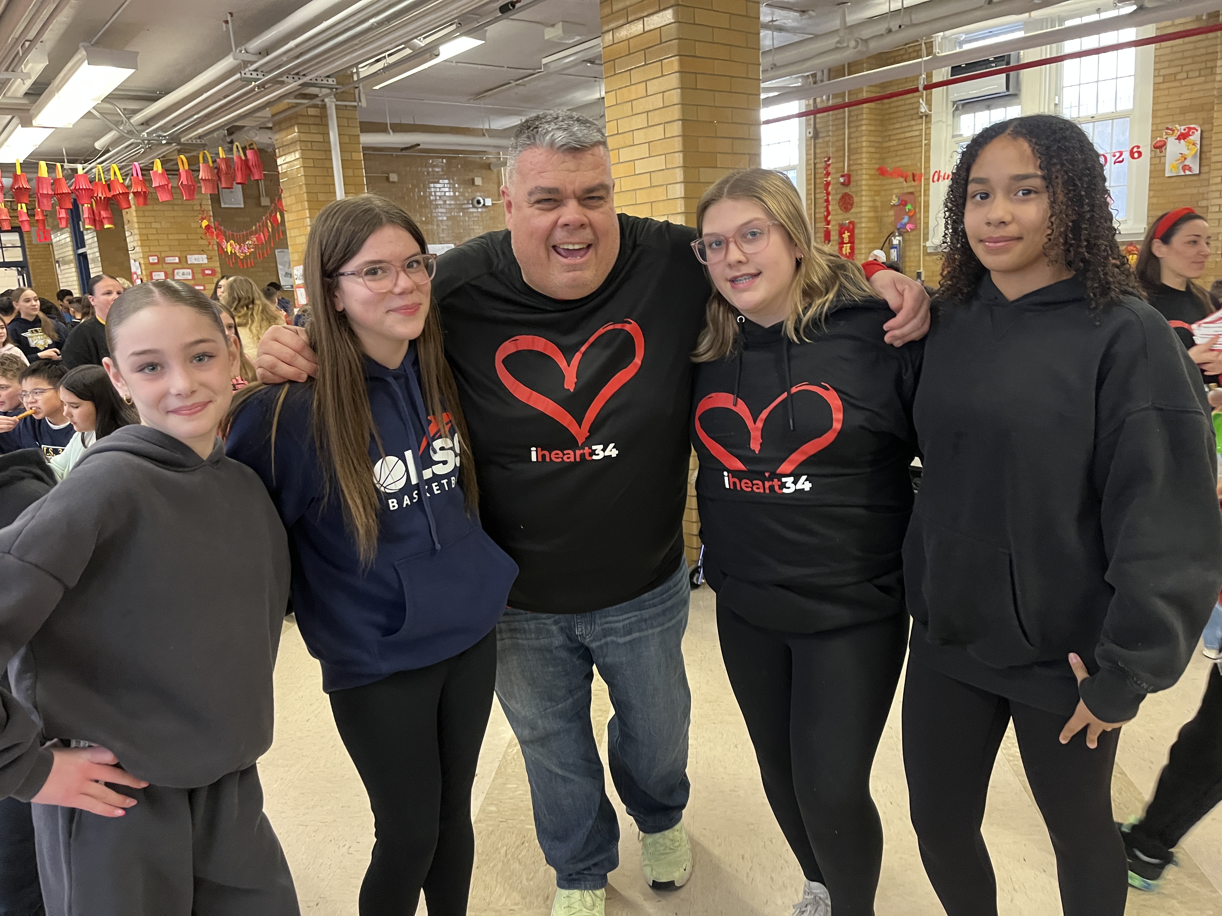 Principal John Boyle is surrounded by 6th graders including his daughter to his right at I.S. 34 in Tottenville, as they took part in National No One Eats Alone Day. The lunchtime program, created by the nonprofit Beyond Differences, aims to make cafeterias more welcoming by encouraging students to connect with classmates they might not usually sit with. Today's lunch also featured dancing. (Advance/SILive.com | Jan Somma-Hammel)
