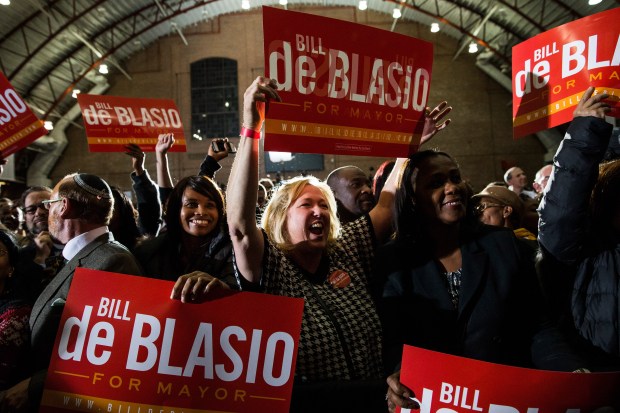 Lori Zeno waves a sign while waiting for de Blasio to walk out at his election night party on November 5, 2013 in New York City.