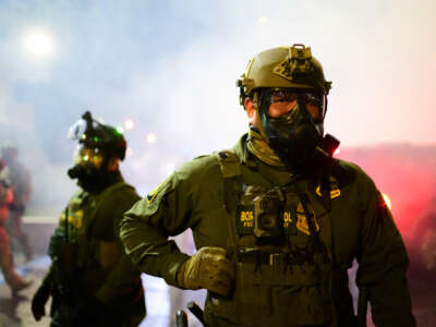 Federal agents walk through tear gas at the U.S. Immigration and Customs Enforcement building on October 18, 2025, in Portland, Oregon.