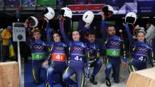 Ukraine's Ihor Hoi, Ukraine's Yulianna Tunytska, Ukraine's Oleksandra Mokh, Ukraine's Andriy Mandziy, Ukraine's Nazarii Kachmar and Ukraine's Olena Stetskiv kneel on one knee after competing in the luge team mixed relay at Cortina Sliding Centre during the Milano Cortina 2026 Winter Olympic Games in Cortina d'Ampezzo on February 12, 2026. (Photo by FRANCK FIFE / AFP via Getty Images)