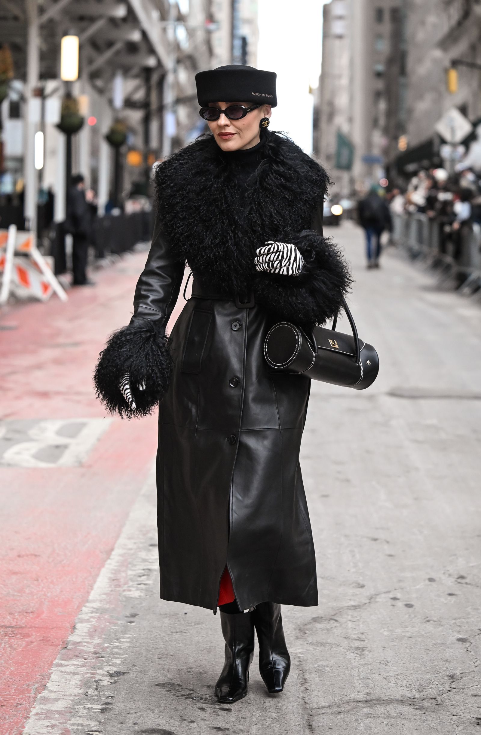 Image may contain Clothing Coat Overcoat Person Accessories Bag Handbag Car Transportation and Vehicle